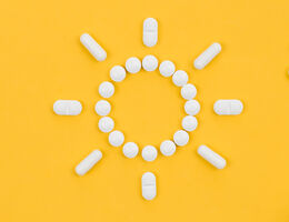 Pills laid out in the shape of a sun.