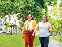 Two smiling women taking a walk.